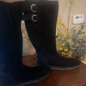 Black, slouchy Uggs with gold buckles